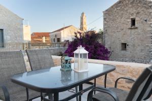 a black table with a lantern on a patio at Mainotti's house with balcony in Areopoli