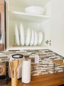 a kitchen with white plates on a shelf at Separate guest suite in Lower Sackville +58 photos