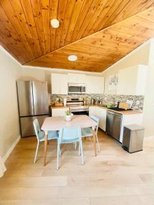 a kitchen with a table and chairs in a room at Separate guest suite in Lower Sackville