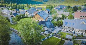 an aerial view of a village with houses and a river at Bohinj Mountain Dreams in Bohinj
