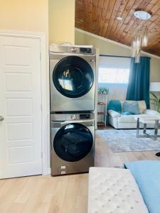 a washer and dryer stacked in a living room at Separate guest suite in Lower Sackville