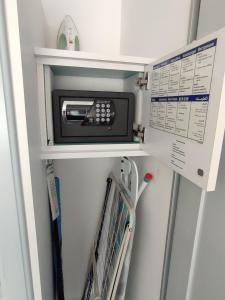 a microwave on a shelf in a room at Nyárfa Vendégház in Balatonmáriafürdő