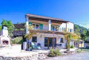 a house with a balcony on the side of it at House Pool Out In The Wilds in Salernes
