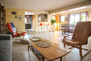 a living room with a wooden table and chairs at House Pool Out In The Wilds in Salernes