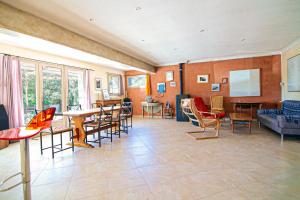 a living room with a table and chairs at House Pool Out In The Wilds in Salernes