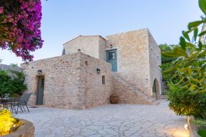 an external view of a stone building with a patio at Mainotti's house with balcony in Areopoli