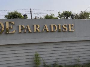a sign for a garage on top of a building at Poolside Paradise in Ghaziabad
