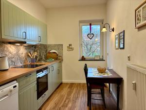 a kitchen with a small table and a window at Bellevue - mit Balkon und Aussicht in Maring-Noviand