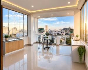 a dining room with a view of a city at Hani Motel Da Nang in Danang