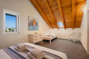 a bedroom with a bed and a desk and a window at Holiday Home Nevera in Kaštela +34 photos