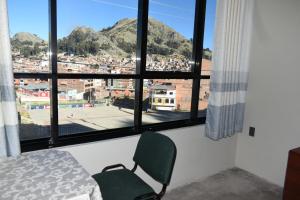 a room with a chair and a window with a view at Nexus Hotel & Coworking in Copacabana
