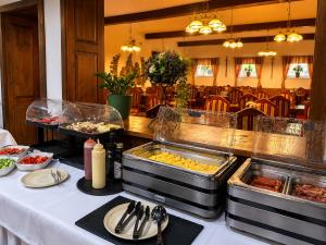 a buffet with food on a table in a restaurant at Hotel ZÁMOCKÁ KORUNA u Hoffera in Nitra
