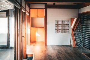 a hallway of a house with wooden floors at ウエダハウス in Ueda