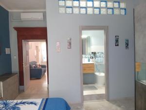 a room with a bed and a living room at Astrolicamus, Intero Alloggio con camera e bagno in Bosa +28 photos