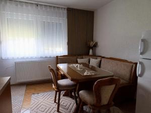 a kitchen with a table and chairs and a refrigerator at Apartmani Srebrenik in Srebrenik +7 photos