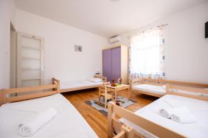 a room with two beds and a window at Kathy House in Slatine