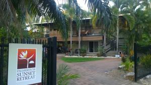 a sign in front of a house with a building at Palmerston Sunset Retreat in Palmerston
