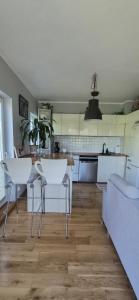 a kitchen with a table and chairs in a room at Apartament Maciejkowa in Szczecin