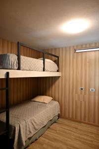 a bedroom with two bunk beds in a room at Chatowasi Mountain Lodge in Santa Eulalia