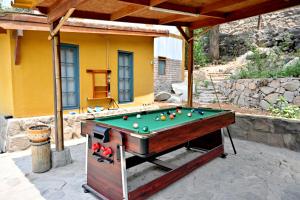a pool table in front of a house at Chatowasi Mountain Lodge in Santa Eulalia