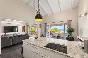 a kitchen and living room with a view of the ocean at Atlantis Beach House in Willemstad