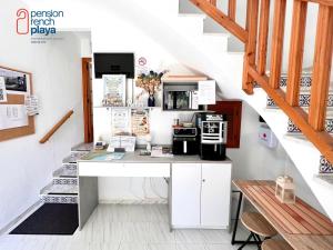 a kitchen with a desk in a stair room at Pensión RENCH in Alcossebre +32 photos