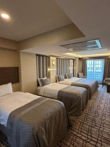 a hotel room with three beds in a room at Green Prusa Hotel in Bursa +137 photos