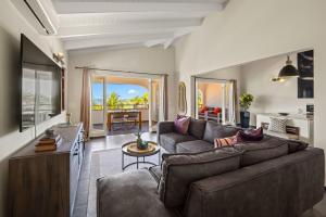 a living room with a couch and a table at Atlantis Beach House in Willemstad