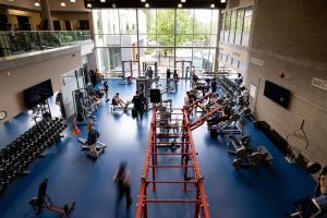 a gym with people exercising in a large room at Hotel Burnaby in Burnaby