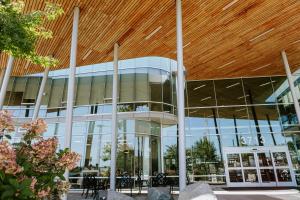 a large glass building with a wooden ceiling at Hotel Burnaby in Burnaby