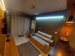 a living room with a couch and a table at Villa Pitanga Pousada in São Martinho