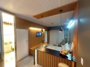a kitchen with a counter with a bowl of fruit on it at Villa Pitanga Pousada in São Martinho
