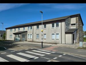 a large building with a street light in front of it at Garden House Rooms in Kirkwall