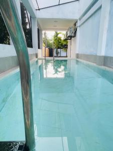 a swimming pool with blue water in a building at Kalupahana Villa in Beruwala