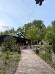 a building with a brick walkway in front of it at Vuk Etno domaćinstvo in Barajevo