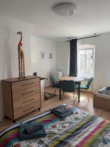 a bedroom with a bed and a dresser and a table at Przy Żelaznym Moście in Kłodzko