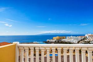 a balcony with a view of the ocean and buildings at Ocean Front Teneriffa 2 Bedroom Penthouse Costa Adeje in Callao Salvaje