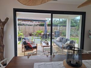a living room with a couch and chairs at Villa Céline - Prestige, Piscine & Jacuzzi in Vielle-Saint-Girons