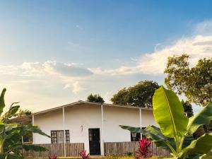 a white house with trees in front of it at Casa Jaguar Viotá in Viotá