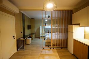 a room with a kitchen with a refrigerator and a table at Kruja Gate in Krujë