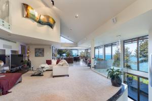 an open living room with a couch and a table at Lodge by the beach - Luxury, Beach access, Ocean views, Private chef in Kaiteriteri