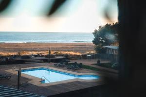 a swimming pool with a view of the beach at Hotel Punta Sirena in Curanipe +23 photos