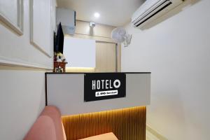 a hotel room with a sign on the wall at Hotel O by OYO S R Galaxy in Kānpur