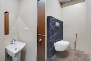 a bathroom with a toilet and a sink at Hotel O by OYO S R Galaxy in Kānpur