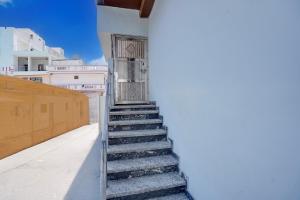 a stairway leading up to a door on a building at Hotel O by OYO S R Galaxy in Kānpur