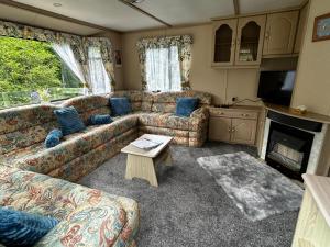 a living room with a couch and a table at 48 River View in Dunoon