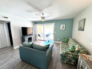 a living room with a couch and a tv at 2BR/1BA Sienna Park Apartment in Sarasota