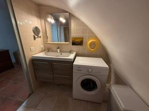 a bathroom with a washing machine and a sink at Le Balcon des Pourcelles in Les Mées +38 photos