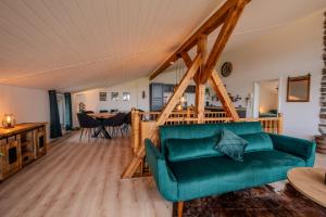 a living room with a green couch and a table at Starkenburger Perle in Starkenburg +31 photos