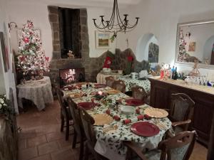a dining room with a table and a christmas tree at Cortijo Esquina B&B Guesthouse in Arboleas
